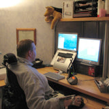 Quadriplegic_in_wheelchair_using_Maverick_Corner_Wheelchair_Desk_with_high_monitor_Shelf